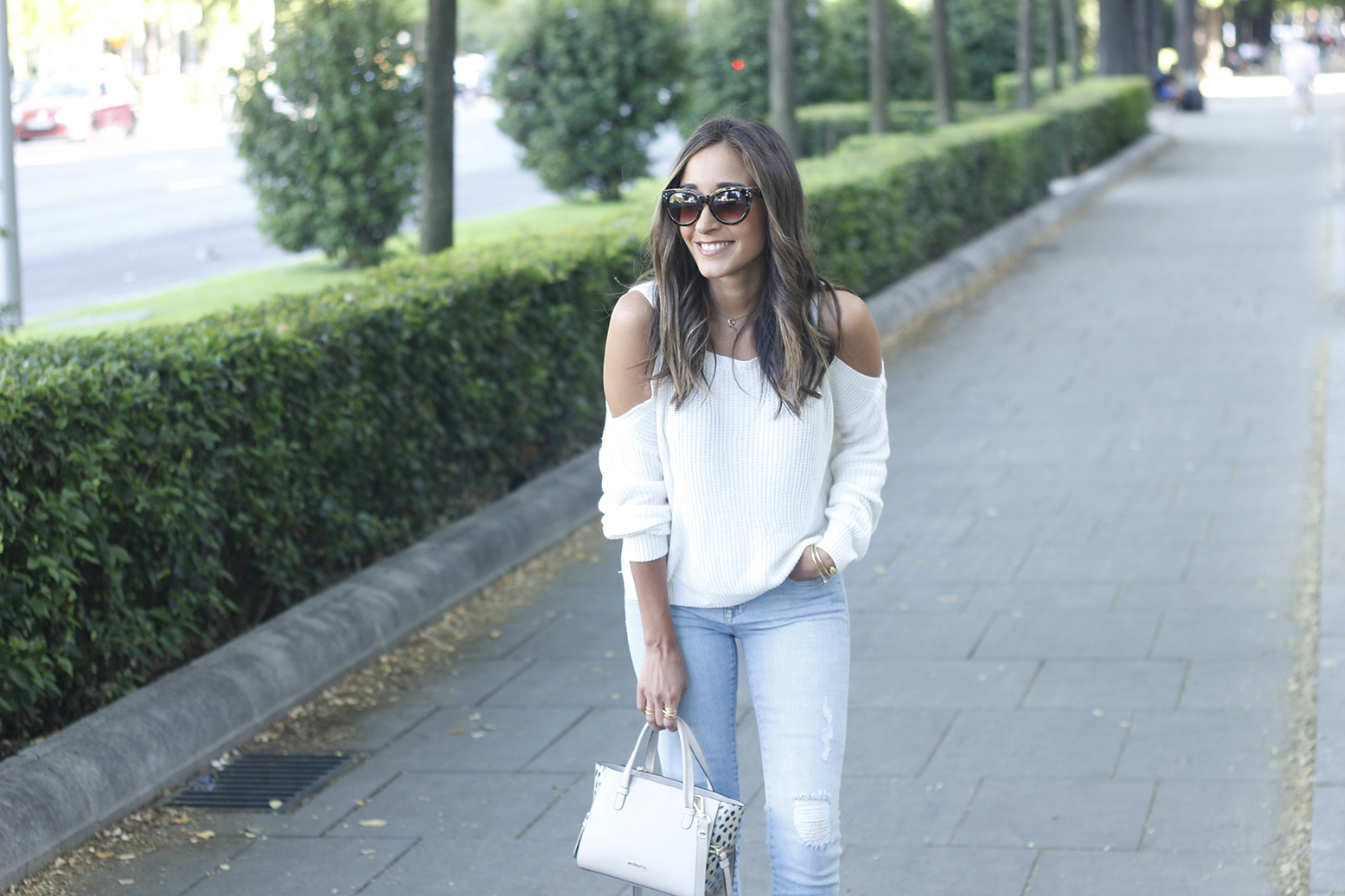 White off the shoulder sweater jeans acosta bag heels outfit style15