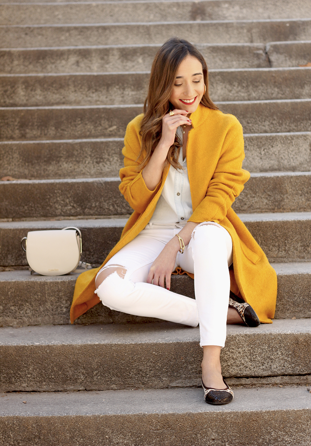mustard coat ripped white jeans leopard flats calvin klein bag street style outfit 201912