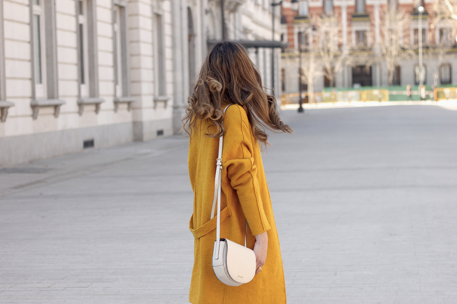 mustard coat ripped white jeans leopard flats calvin klein bag street style outfit 201910