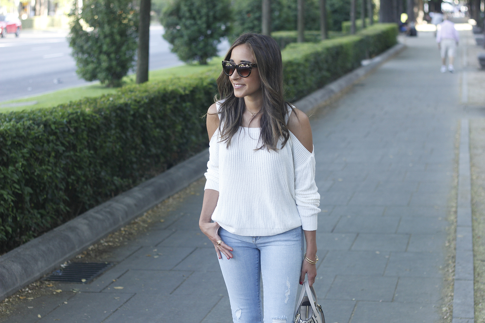 White off the shoulder sweater jeans acosta bag heels outfit style10
